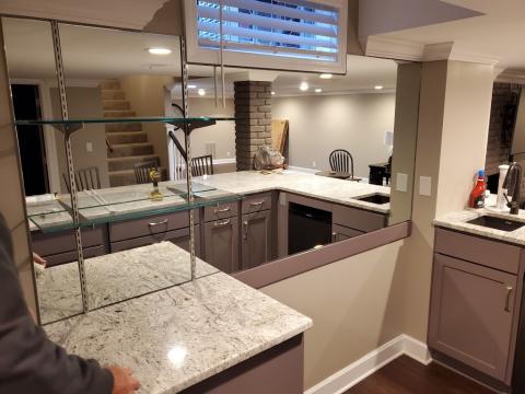 A home bar with an impressive glass and mirror install
